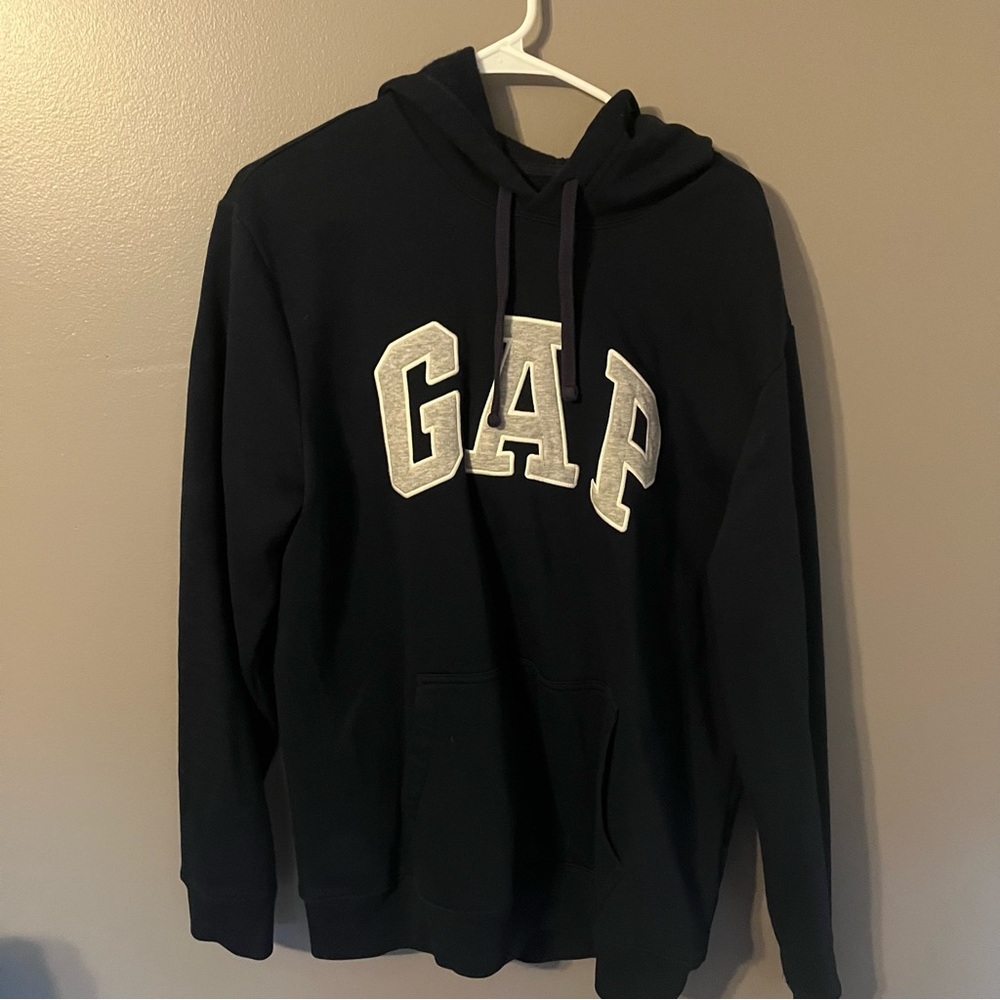 This is a navy blue gap hoodie with a grey color logo that hits true to size